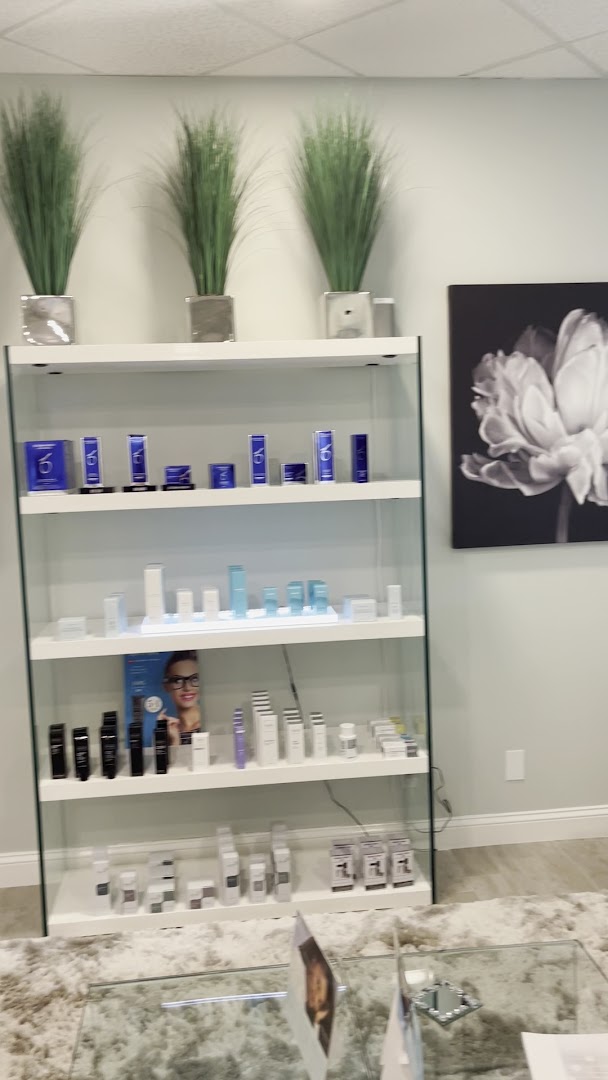 The Laser Lounge Spa reception with branded glass — Naples, FL